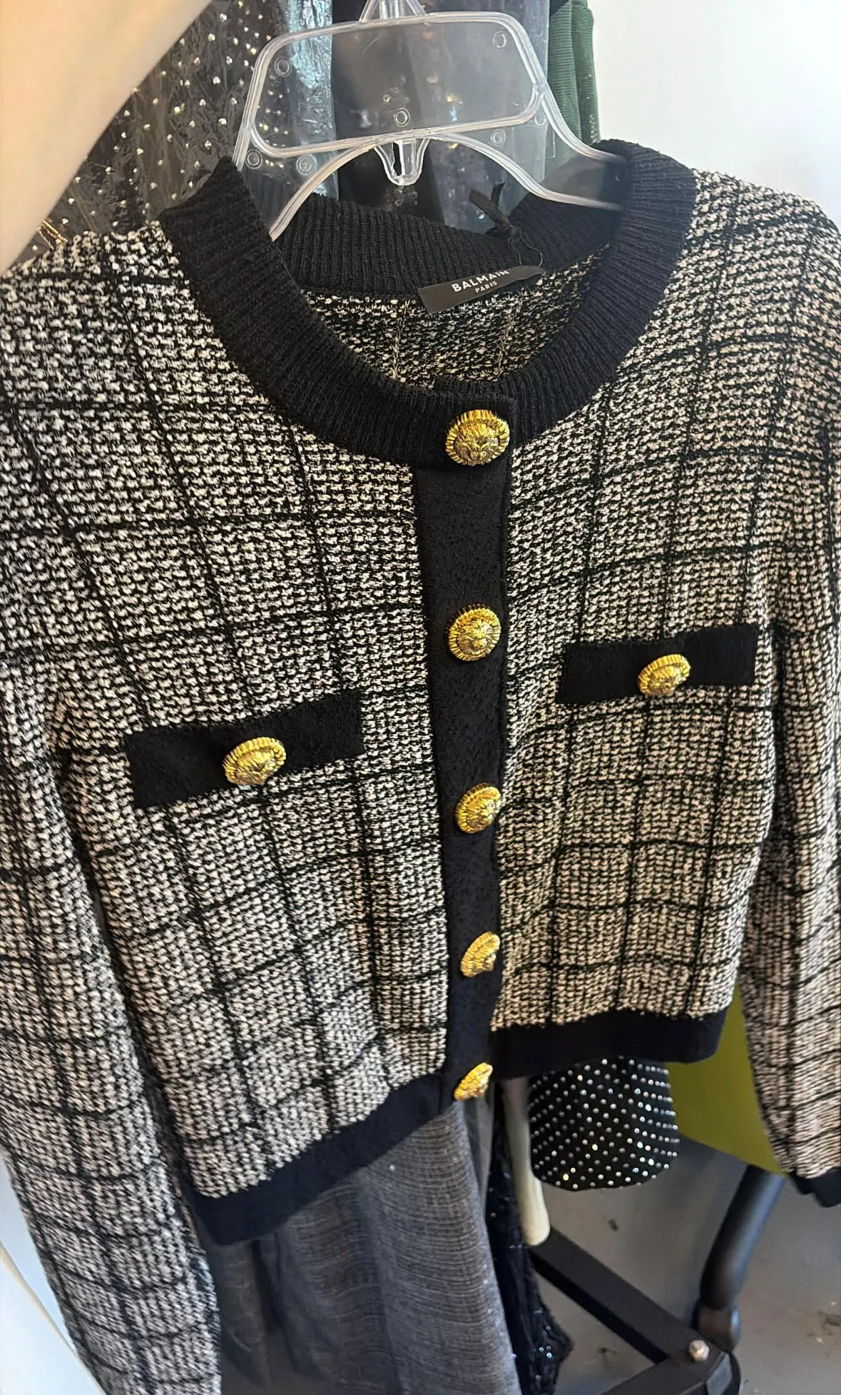 Balmain jacket on the hanger in the studio, showing the gold lion buttons