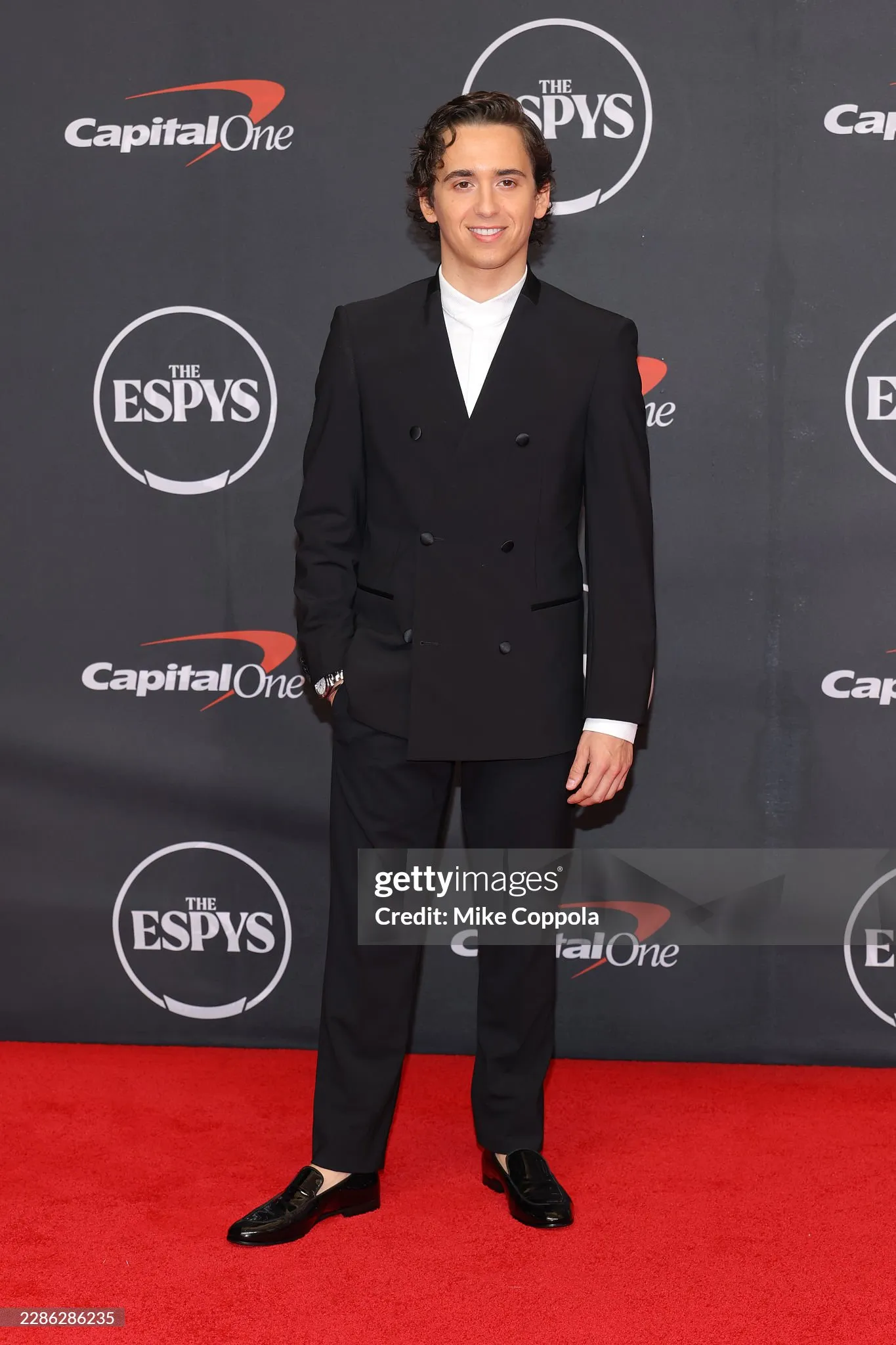 Marcello Hernandez in a black double-breasted suit