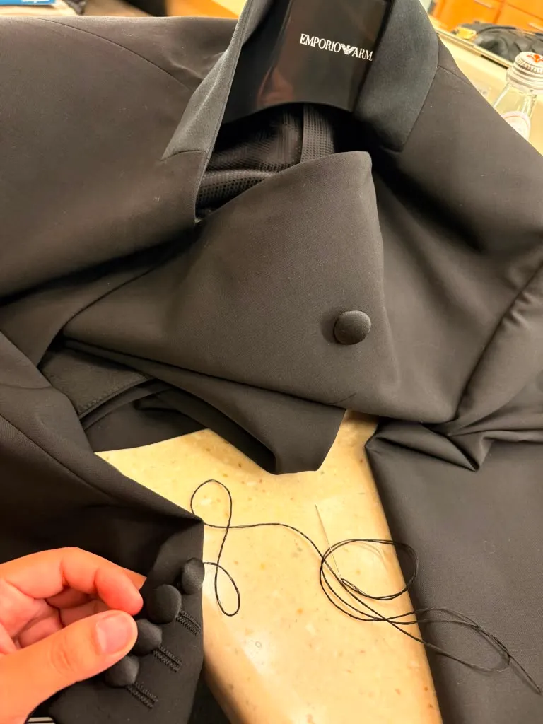 Hand-sewn buttons on the tuxedo jacket placket